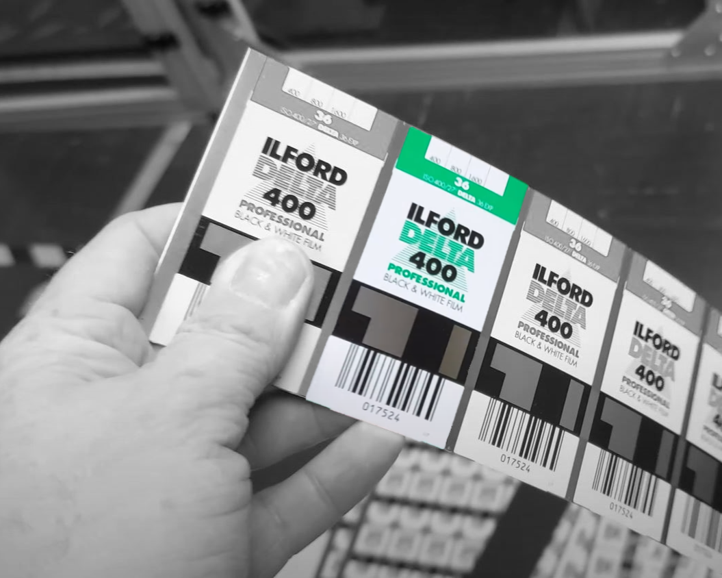 Hand holding a strip of four ILFORD black and white film boxes, each labelled 400 Professional.